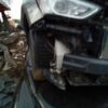 A car that has been smashed in the middle of its front end.