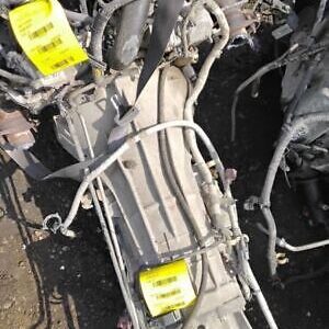 A car engine with two yellow tags on it.