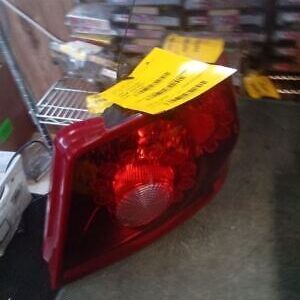 A red car tail light sitting on top of a table.