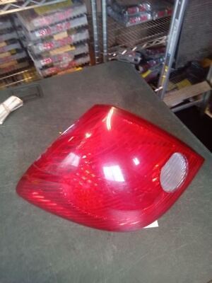 A red car tail light sitting on top of a table.