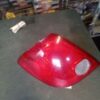 A red car 's tail light on the floor.