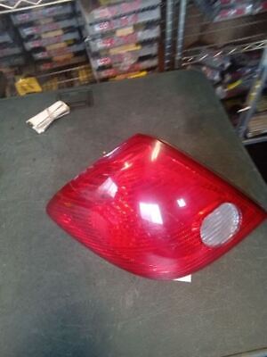 A red car 's tail light on the floor.