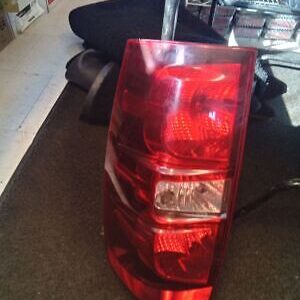 A red and white car tail light on the floor