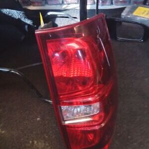 A red tail light on the back of a truck.