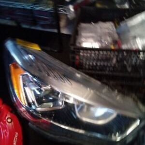 A car headlight with some other items in the background