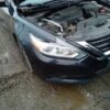A car that has been broken down and is in the street.