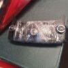 A black bag with some silver stickers on it