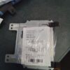 A package of paper is wrapped around the bottom of an electronic device.