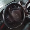 A car steering wheel with the dashboard and steering wheels turned on.
