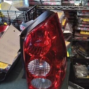 A red and black car tail light sitting on top of a table.