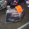 A car headlight with an orange tag on it.
