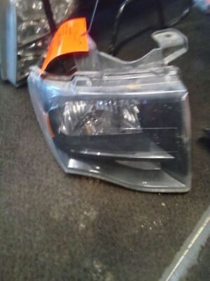 A car headlight that is broken and sitting on the floor.