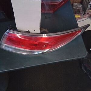 A red and clear car tail light on top of a table.