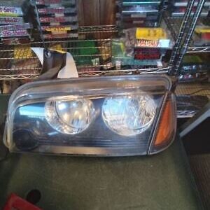 A car headlight sitting on top of the floor.