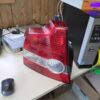 A red and white car tail light on top of a desk.