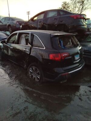 A black car parked in the middle of a parking lot.