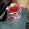 A red and clear car tail light on top of a table.