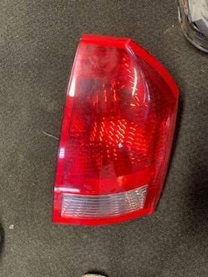 A red tail light sitting on the ground.