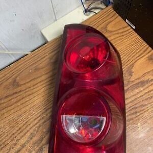 A red tail light sitting on top of a wooden table.