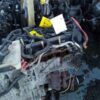 A pile of old engines and parts in the dirt.