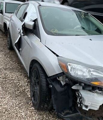 A silver car that has been smashed in the side of it.