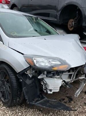 A white car that has been smashed in the back of it.