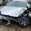 A car that has been smashed in to pieces.