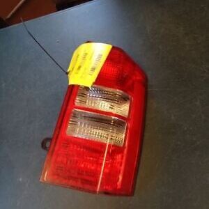 A red and yellow car tail light on top of a table.