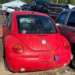 A red car parked in the middle of a parking lot.