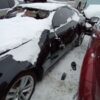 A car that has been smashed in the snow.