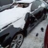 A car that has been smashed in the snow.