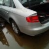 A silver car is parked in the water.