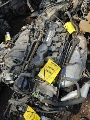 A pile of old car parts with some yellow tags on it.