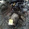 A car engine with many parts on the ground