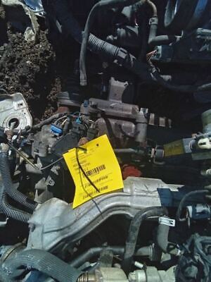 A pile of old car parts with a yellow tag on it.