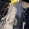 A white piece of metal sitting on top of rocks.