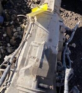 A white piece of metal sitting on top of rocks.