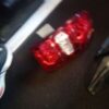 A red light sitting on the floor next to a bicycle.