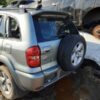 A silver suv with its tire on the ground