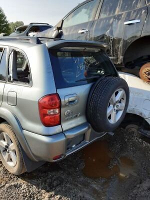A silver suv with its tire on the ground