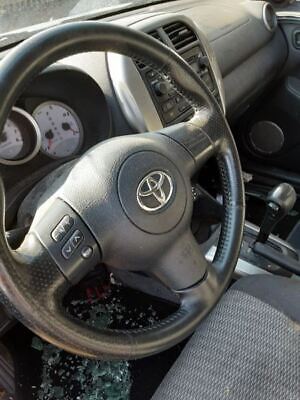 A steering wheel of a car with the dashboard turned on.