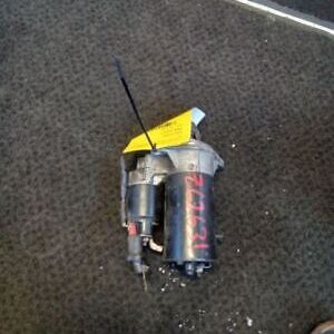 A broken drill on the ground with a yellow sticker.