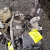 A car engine with some parts on the ground