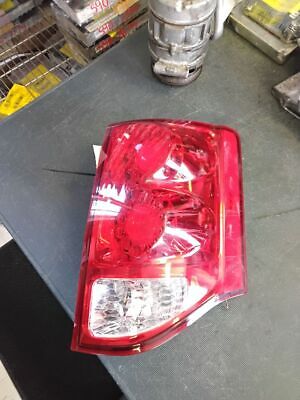 A red and white car tail light on the floor