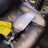 A black leather chair with a white and yellow sign on it.