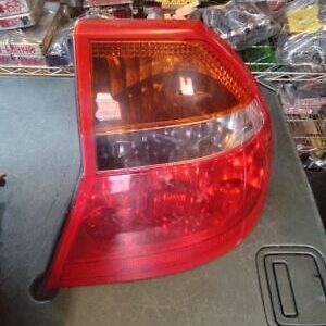 A red and white tail light sitting on top of a table.