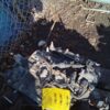 A pile of debris sitting next to a fence.