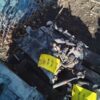 A pile of rubble with yellow signs on top.