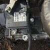 A car engine with the brake pedal on it