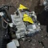 A car engine that is broken and laying on the ground.